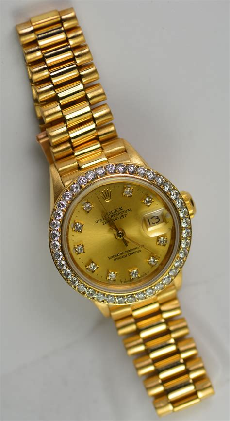 rolex watch with diamond bezel.